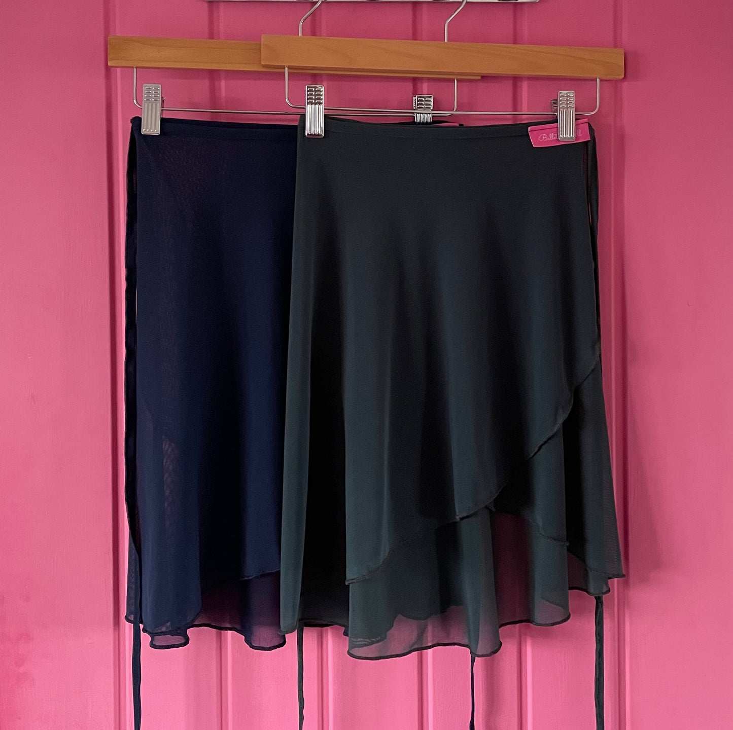 Charcoal Grey & Navy colour skirts with sheer overlay on a pink background