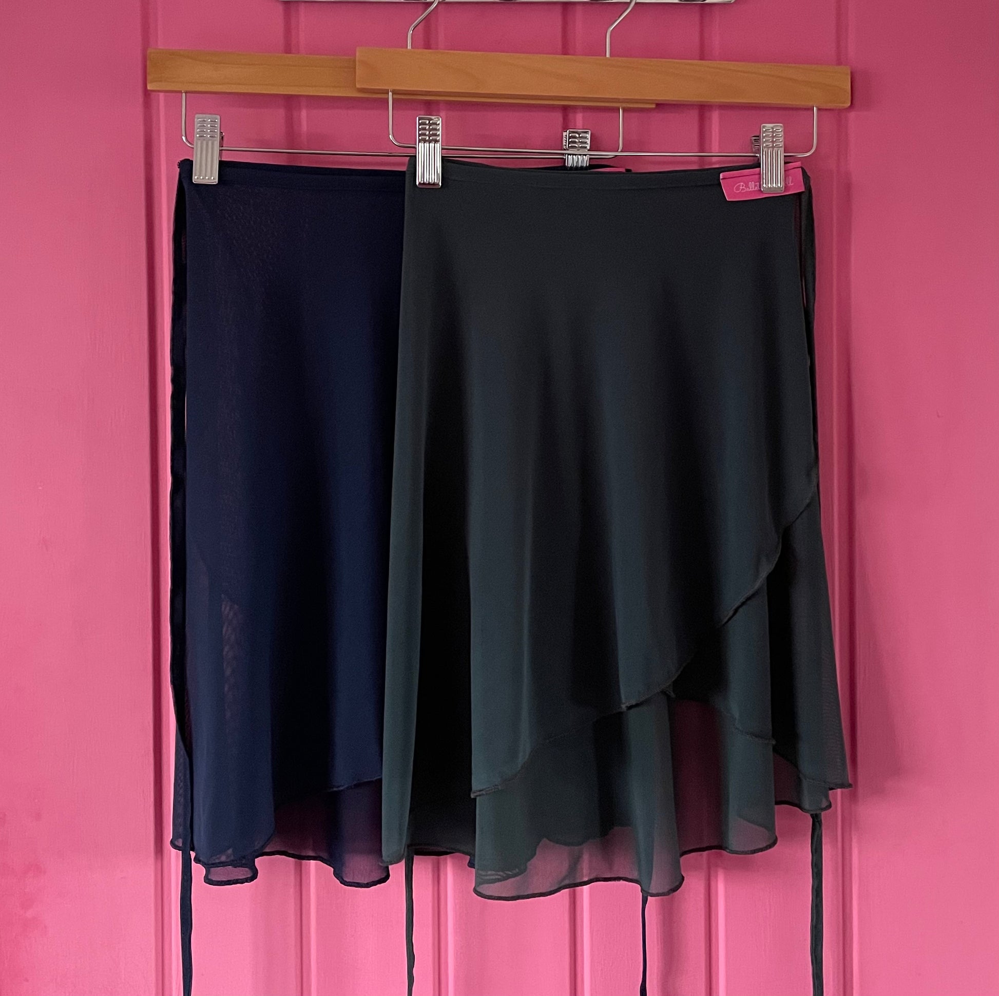 Charcoal Grey & Navy colour skirts with sheer overlay on a pink background
