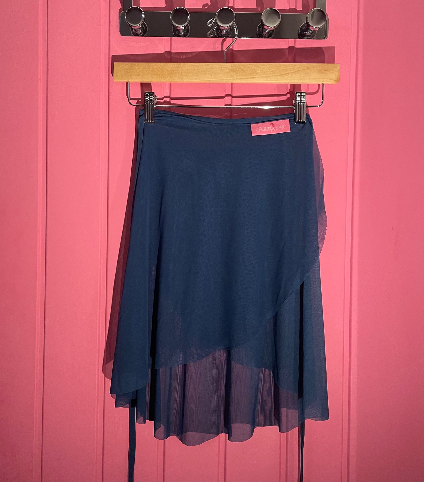 Blue colour skirts with a sheer overlay on a  pink background