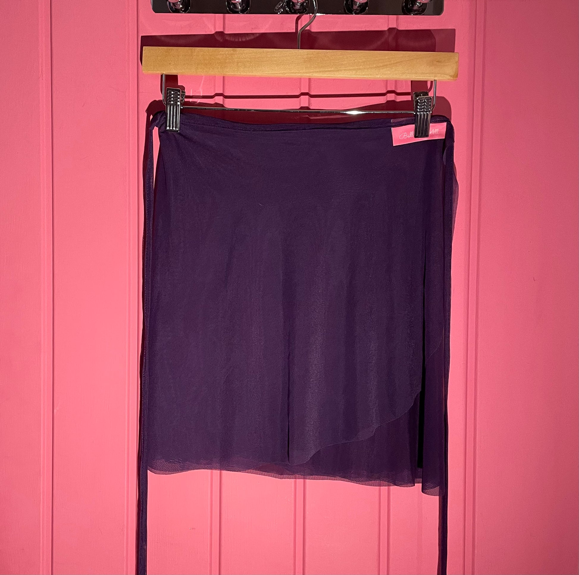 Purple colour skirts with a sheer overlay on a Pink background