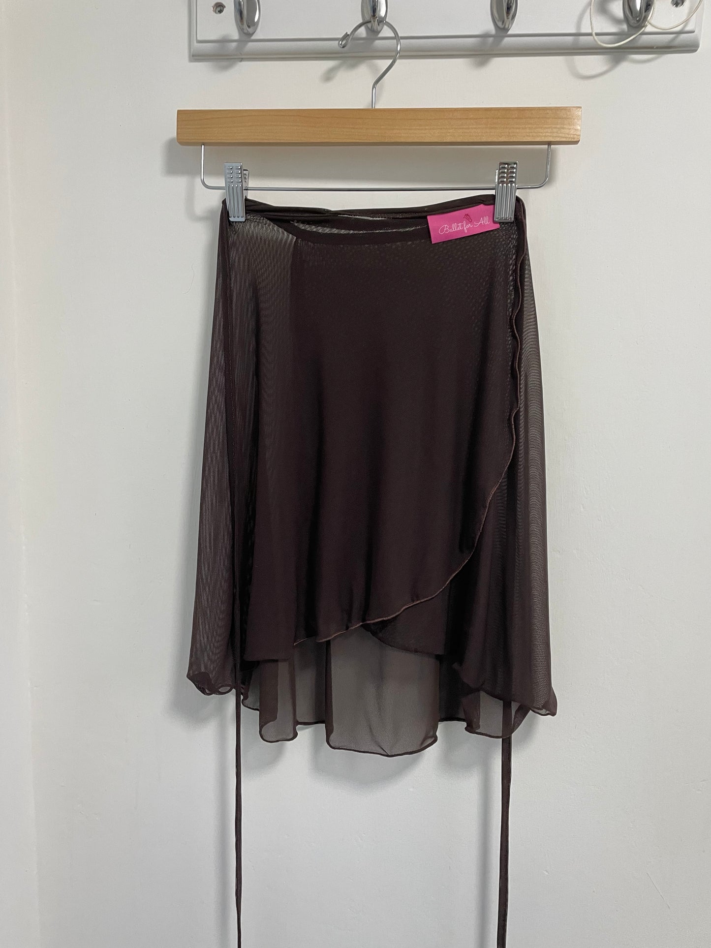 Chocolate colour skirts with a sheer overlay on a white background