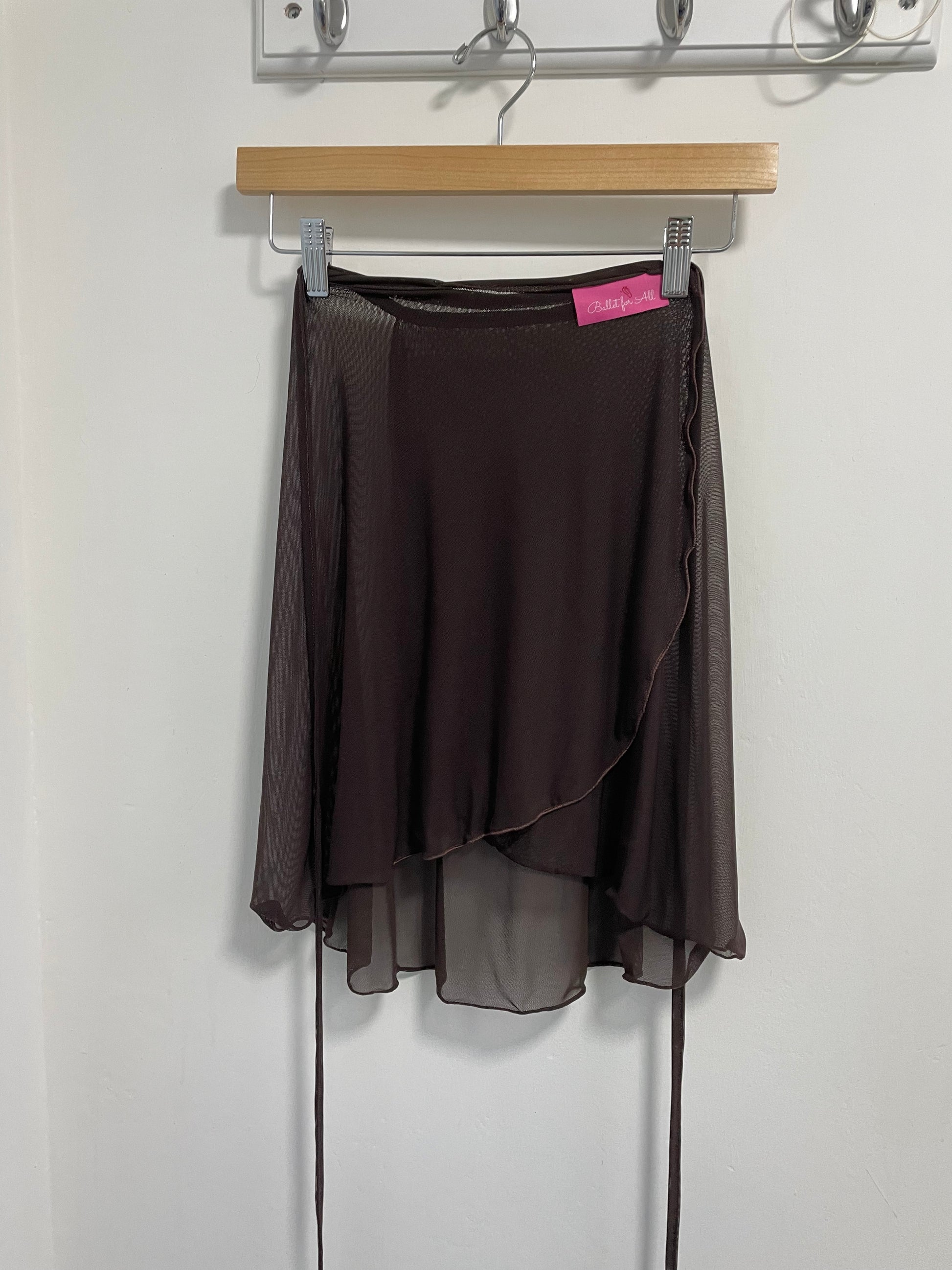 Chocolate colour skirts with a sheer overlay on a white background